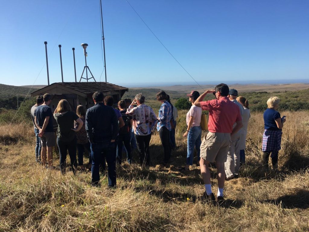 group discusses outside weather station