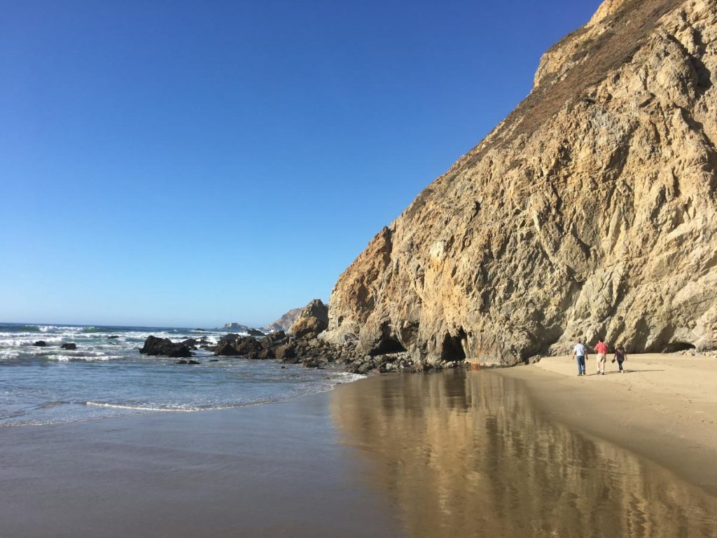 attendees walking beach line