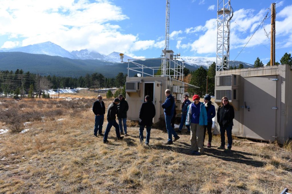 members of meeting discussing weather equipment 